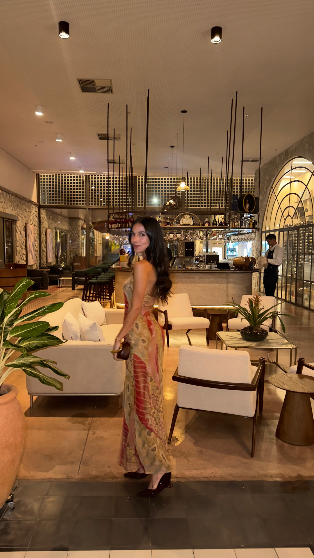 Printed silk maxi dress styled for a hotel bar evening